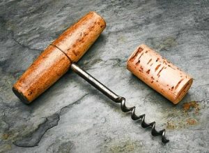 photo of a traditional steel screw bottle opener with a wooden handle